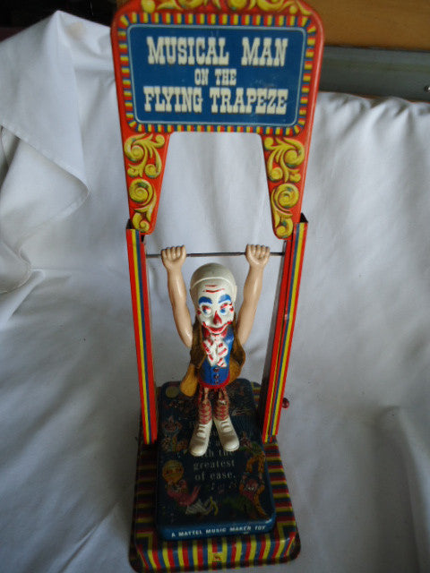Mattel Wind Up Toy Pressed Tin Litho Musical Man On The Flying Trapeze - Roadshow Collectibles